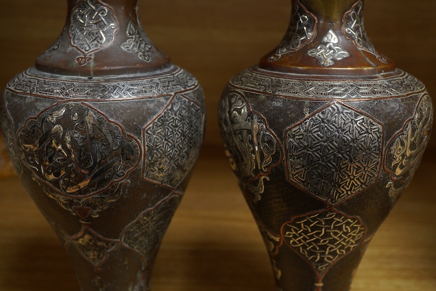 A pair of Cairoware silver and copper inlaid brass vases, 24cm high